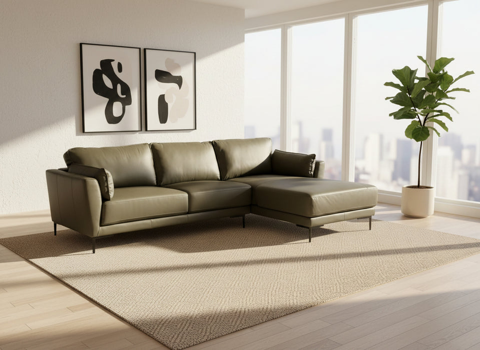 Gray sectional sofa on a wooden floor with a white backdrop