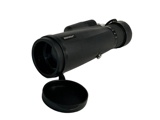 Black monocular on a white surface with a brand label in the background