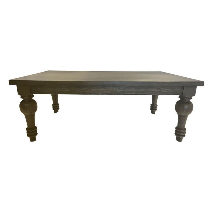 Wooden table with turned legs on a white draped background