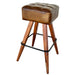 Wooden stool with brown cushioned seat on a staircase