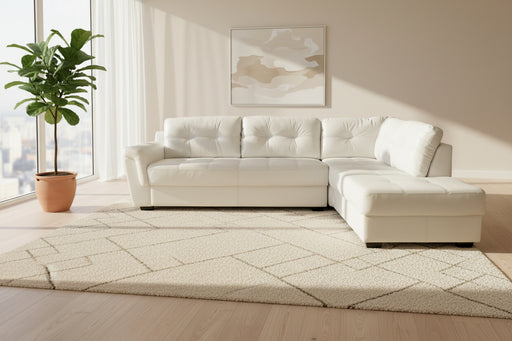 White sectional sofa in a showroom setting with a gray carpeted floor.