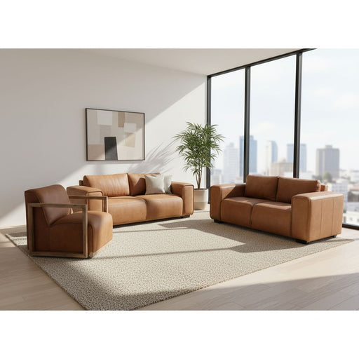 Brown leather sofa set on a concrete surface with a building in the background