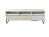White entertainment console on a gray floor with a white backdrop