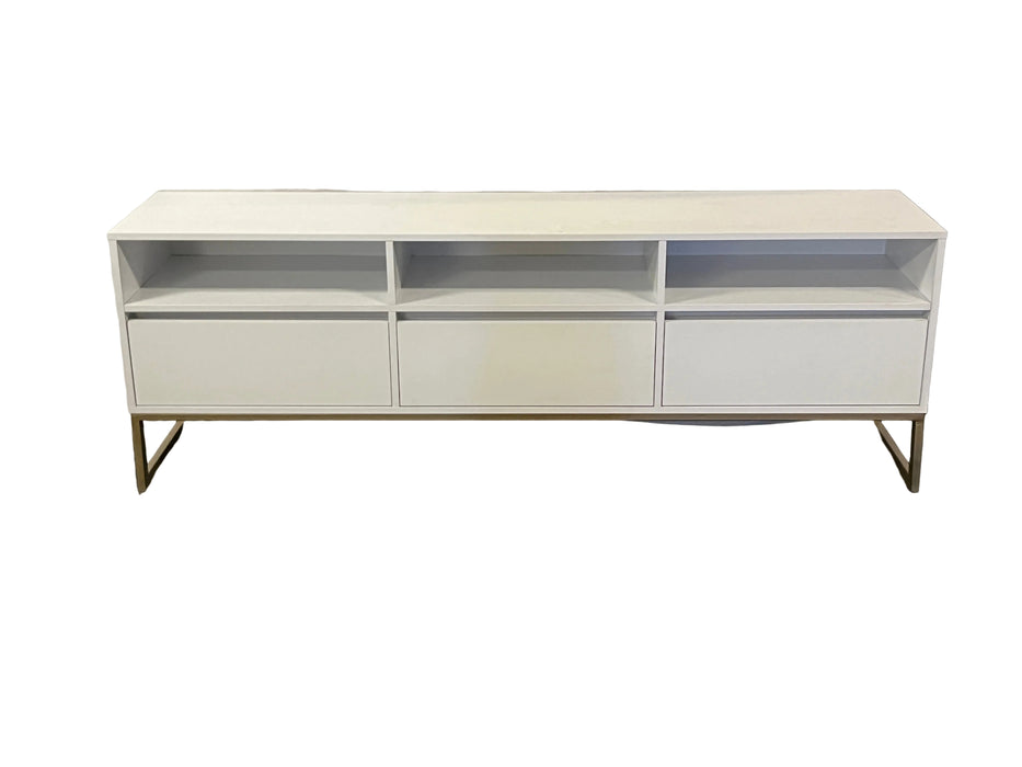 White entertainment console on a gray floor with a white backdrop