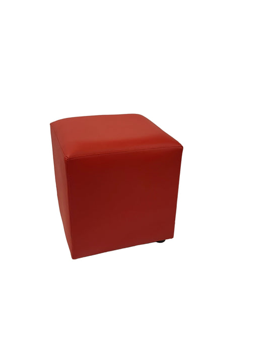 Red cube on a white fabric background
