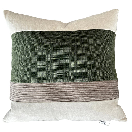 Decorative pillow with a green and brown pattern on a gray background