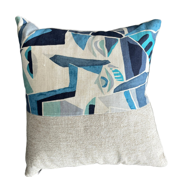 Decorative pillow with abstract face design on a gray background