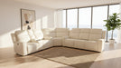Beige sectional sofa in a modern living room with large windows and a plant.