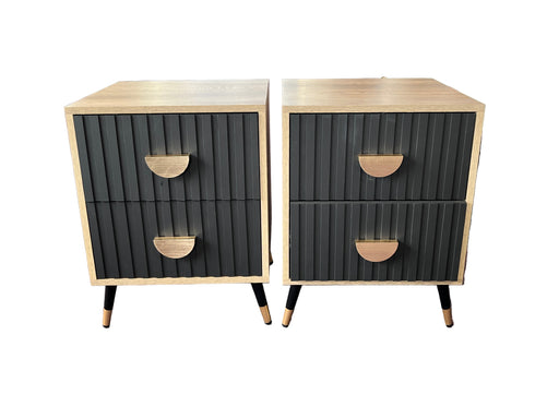 Two black and beige nightstands with ribbed texture in a store setting.
