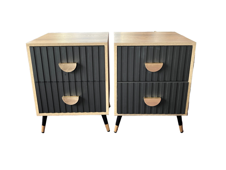 Two black and beige nightstands with ribbed texture in a store setting.