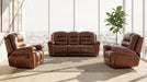 Brown leather sofa set in a bright living room with large windows.