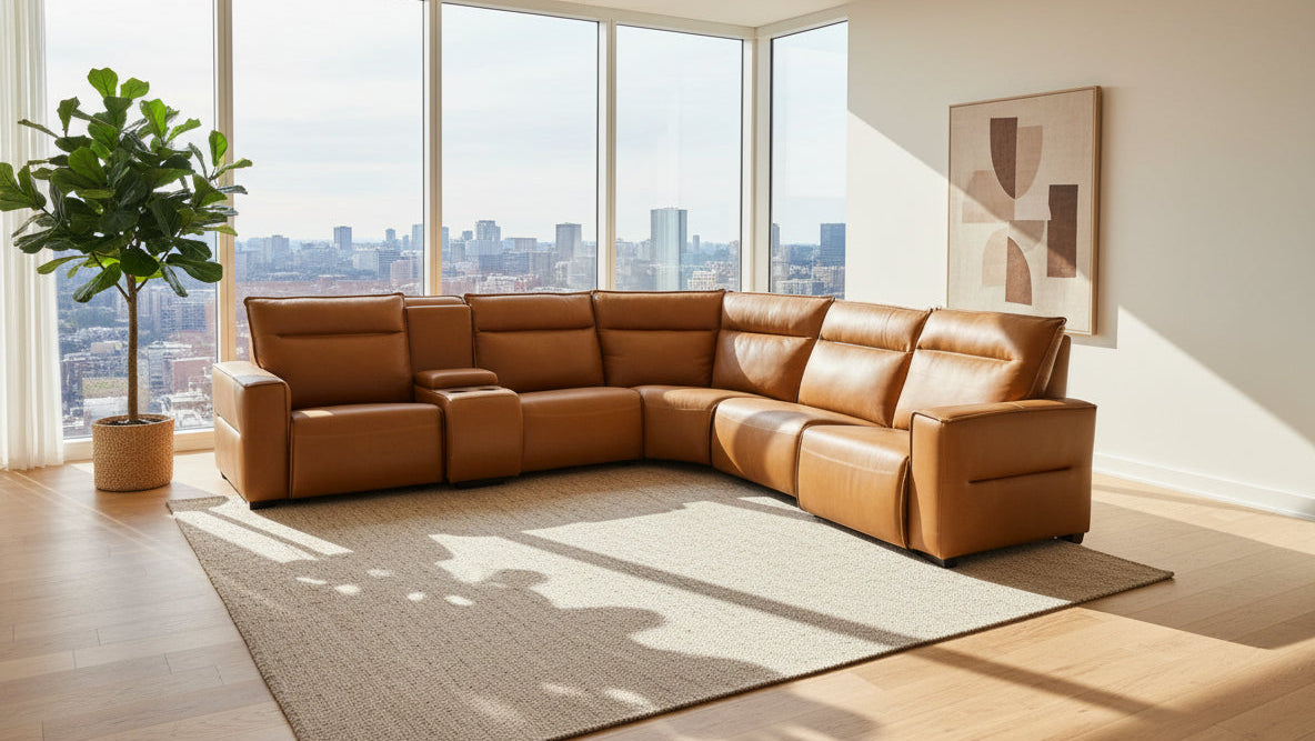 Brown sectional sofa in a warehouse setting with boxes and tarps in the background.