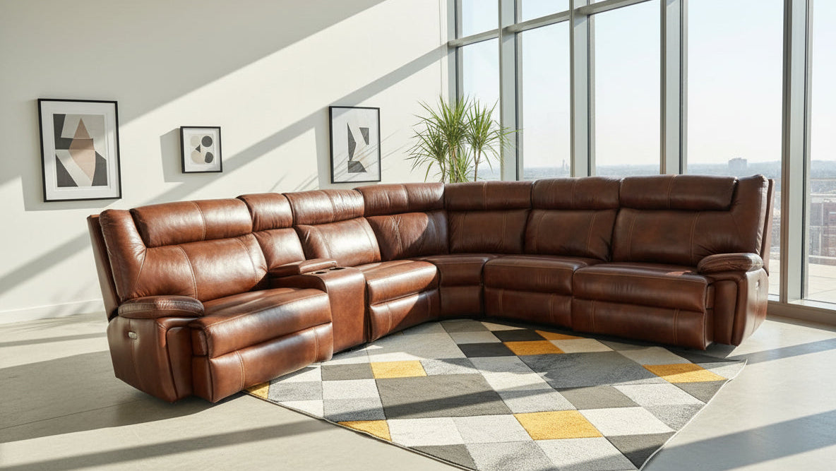 Brown leather sectional sofa in a living room with large windows and a geometric rug.