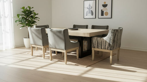 Dining room with a wooden table and chairs, light-colored walls, and a plant.