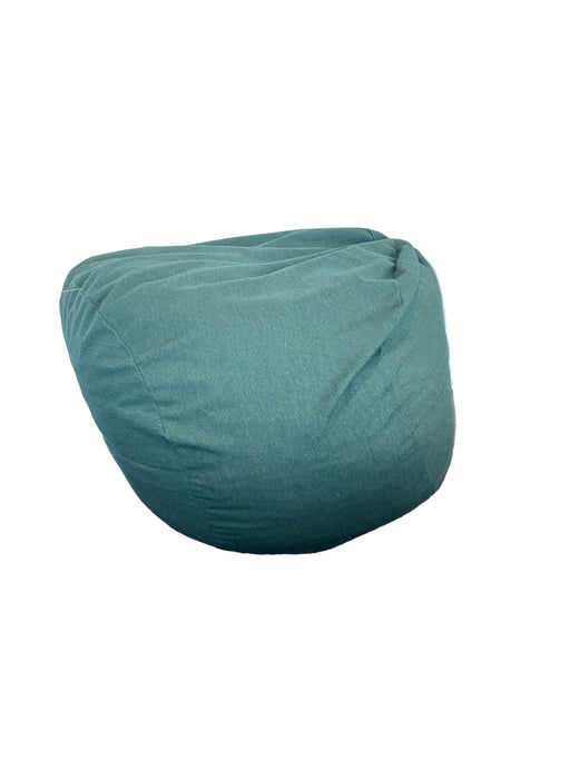 Green turban on a white surface with a brown background