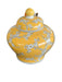 Yellow ceramic vase with floral patterns on a dark background