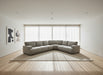 Gray sectional sofa in a large indoor space with high ceilings and exposed beams.