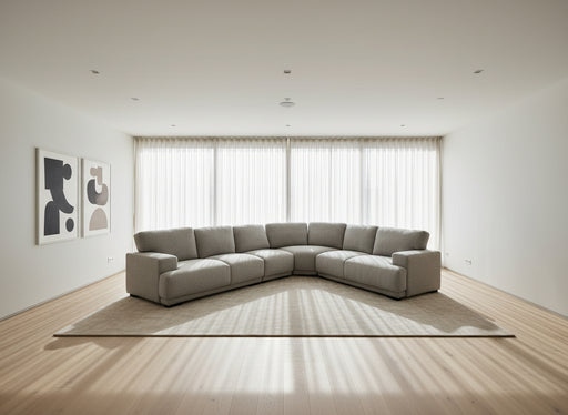 Gray sectional sofa in a large indoor space with high ceilings and exposed beams.