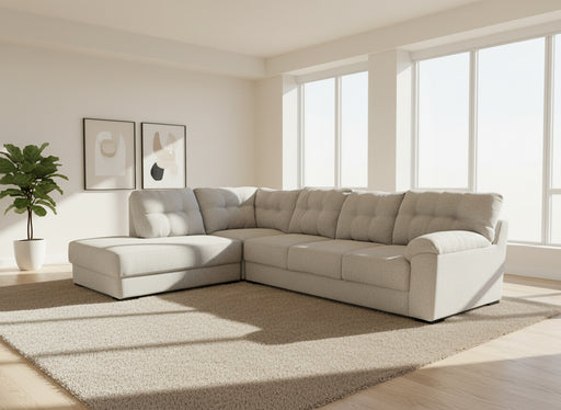 Gray sectional sofa in a room with a white sheet covering a window.