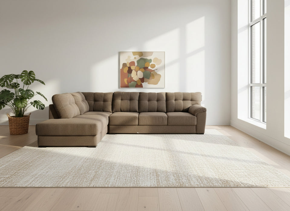 Brown sectional sofa in a room with a white sheet covering furniture.