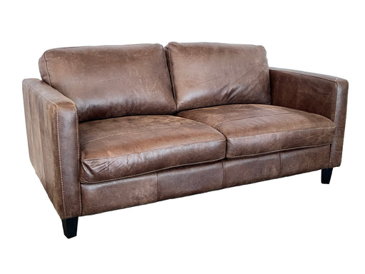 Brown leather sofa on a gray carpet with a white wall background