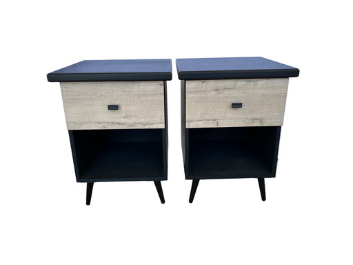 Two nightstands with a wooden finish and black accents on a gray floor.