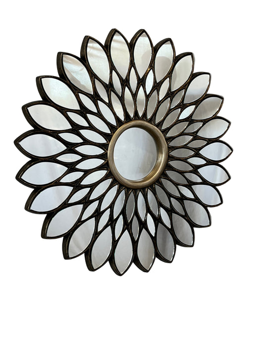 Decorative wall mirror with a sunflower design on a gray surface