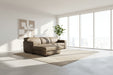 Brown sectional sofa in a room with white draped fabric