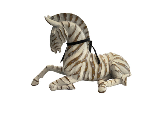 Plush zebra toy on a white surface with a clear plastic cover