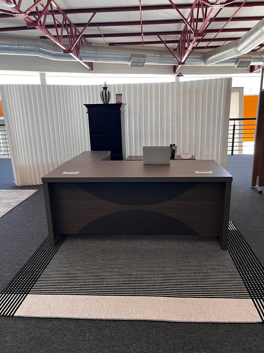 Modern office interior with a black desk and chair.