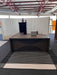Modern office interior with a black desk and chair.