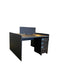 Modern office desk with a computer monitor in an open-plan office setting.