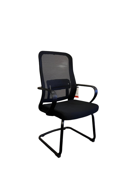 Black office chair against a white wall and purple carpet
