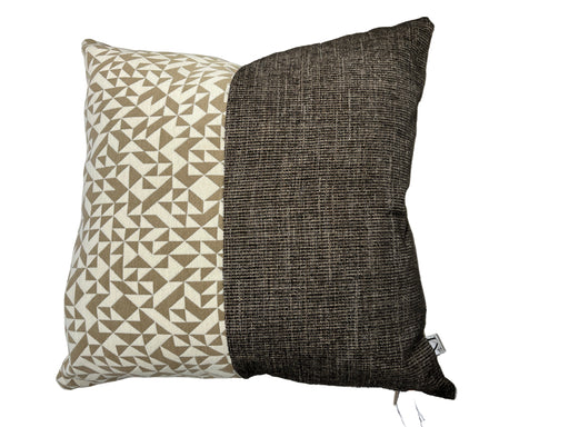 Two pillows, one with a geometric pattern and the other plain, on a light-colored sofa.