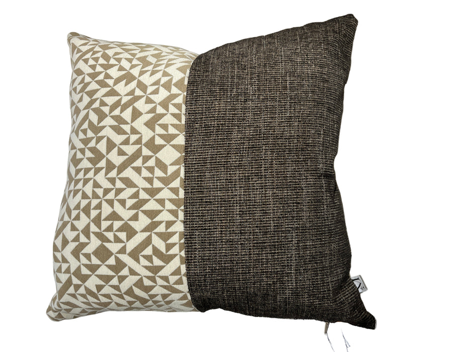 Two pillows, one with a geometric pattern and the other plain, on a light-colored sofa.