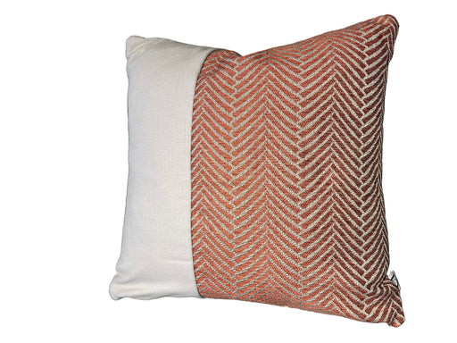 Textured pillow with a herringbone pattern on a gray sofa