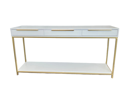 White console table with gold legs and trim against a white backdrop