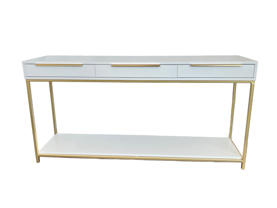 White console table with gold legs and trim against a white backdrop