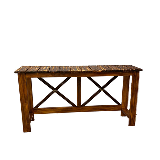 A rustic wooden console table with a slatted top and X-shaped support beams, photographed in a warehouse or showroom setting with a white draped backdrop and concrete floor.