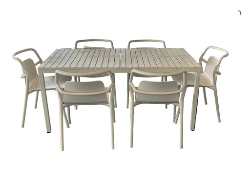 Outdoor furniture set with a table and chairs on a gray carpeted floor.