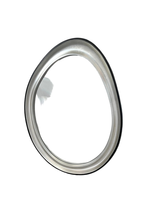 Round metallic object on a white fabric background