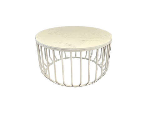 Round white table with decorative metal base  