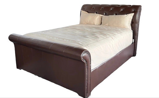 Brown upholstered bed with beige bedding on a white background