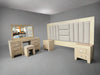 Beige bedroom furniture set with a bed, dresser, and mirror in a room.