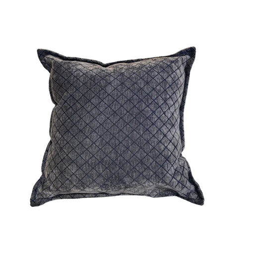 Quilted gray pillow on a beige sofa