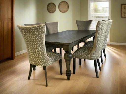 Dining table with four patterned chairs on a white backdrop