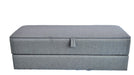 Gray rectangular box with a handle on a textured white surface