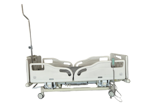 Hospital bed in a room with a person partially visible on the left
