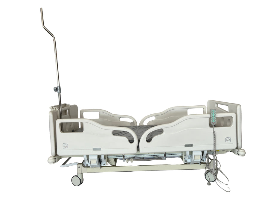 Hospital bed in a room with a person partially visible on the left