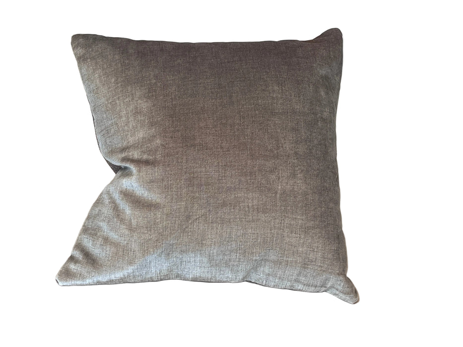 Gray pillow on a beige bed